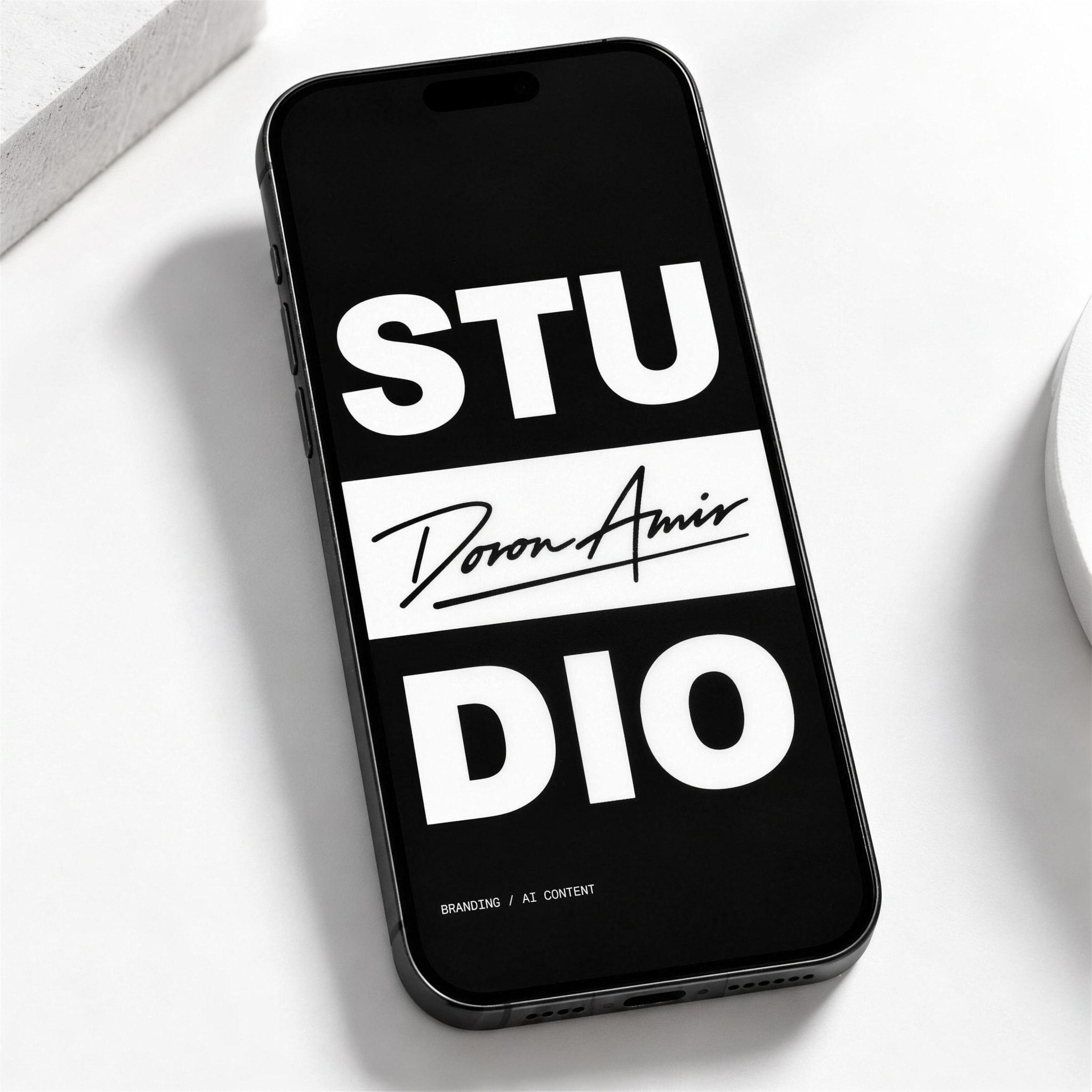 Phone with a black STUDIO screen and the signature on a white band