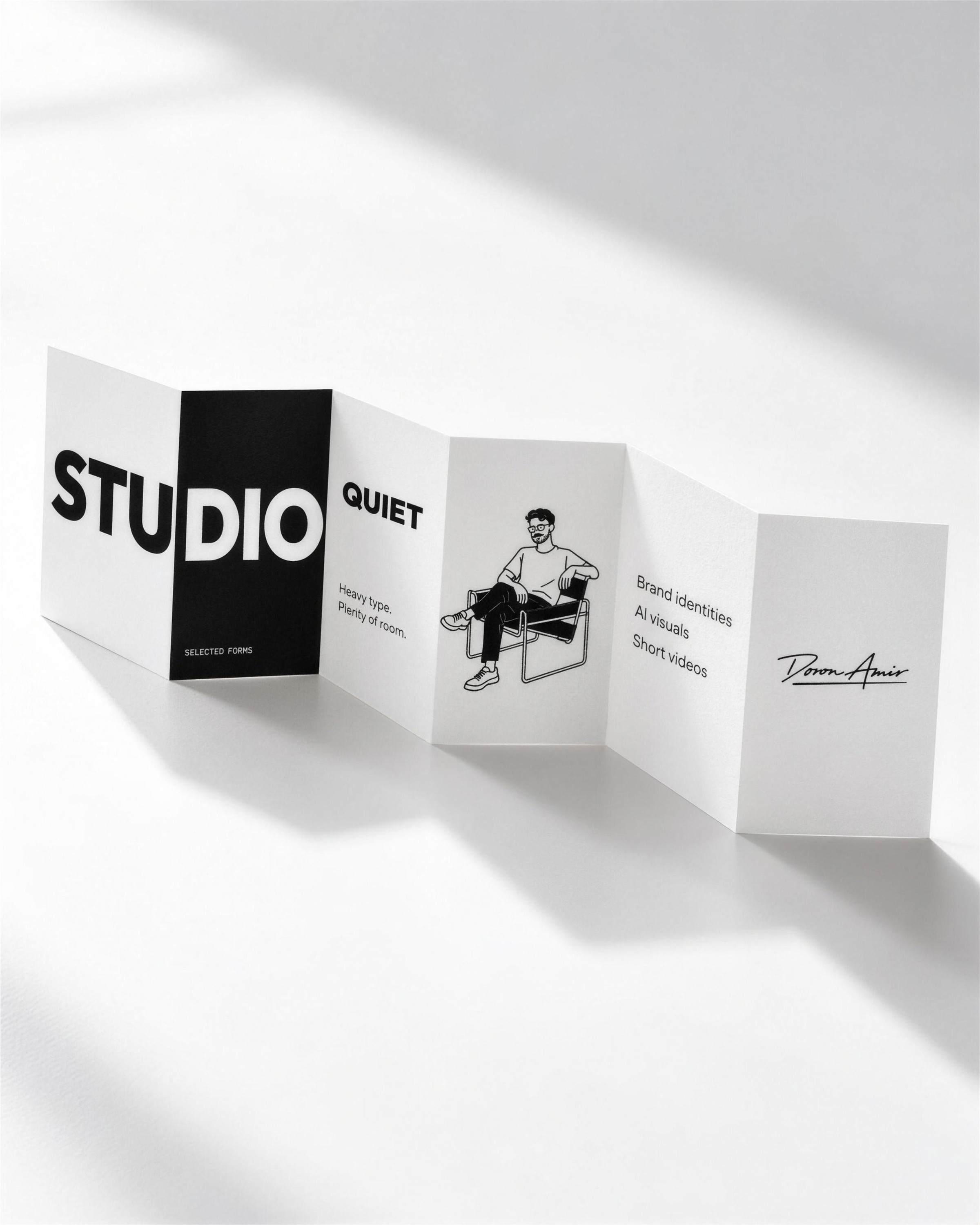 Folded leaflet with STUDIO, the seated character and the signature