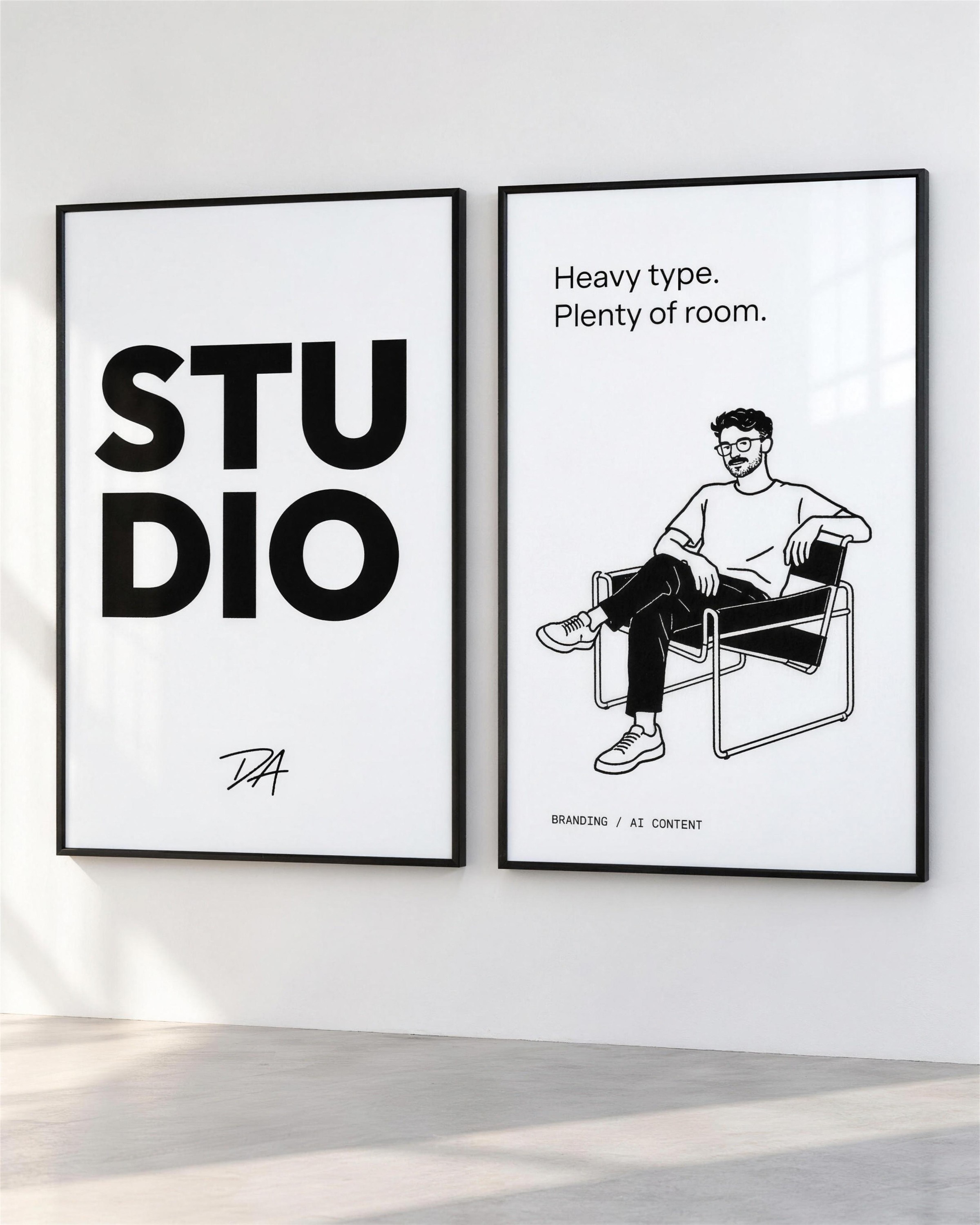 Two framed posters: STUDIO with the DA, and the seated character with Heavy type. Plenty of room.