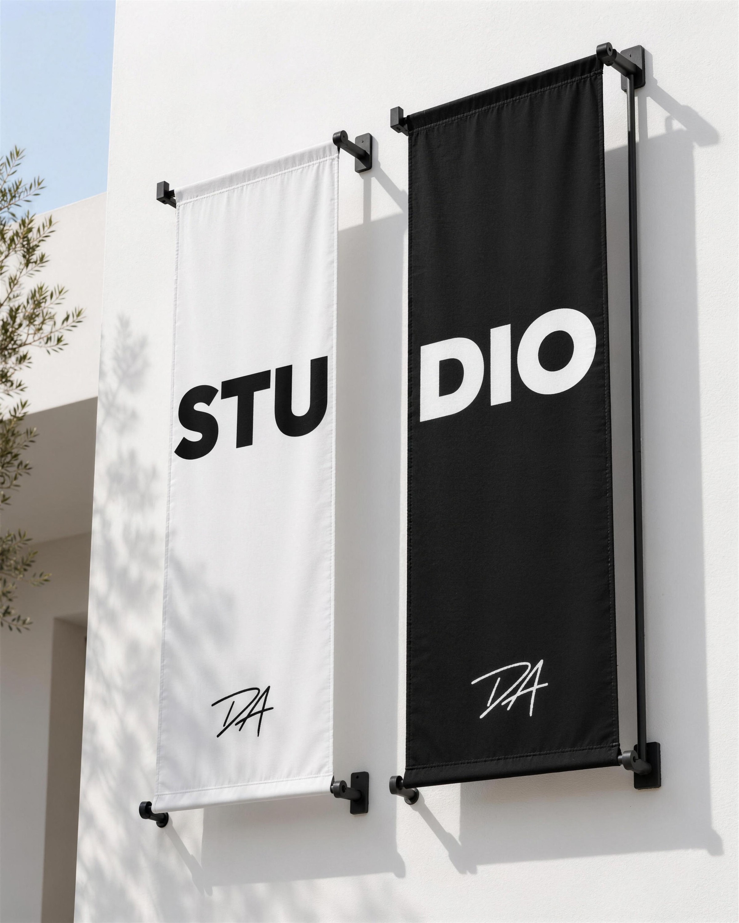White and black wall banners spelling STU DIO with the DA monogram