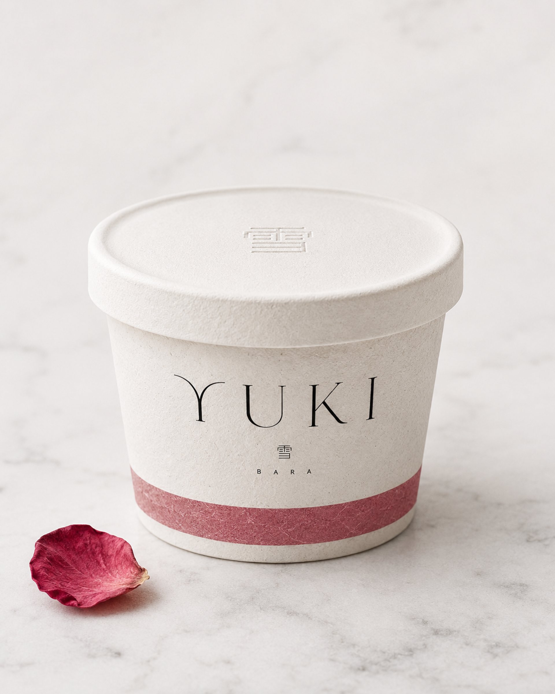 YUKI ice cream tub with a pink band and a rose petal